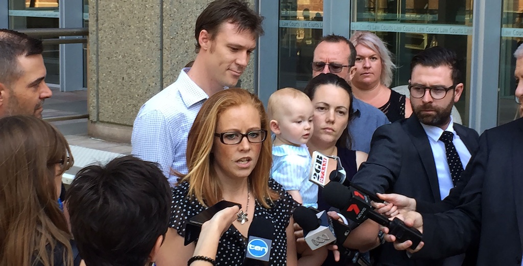 Photo of a community group outside a court